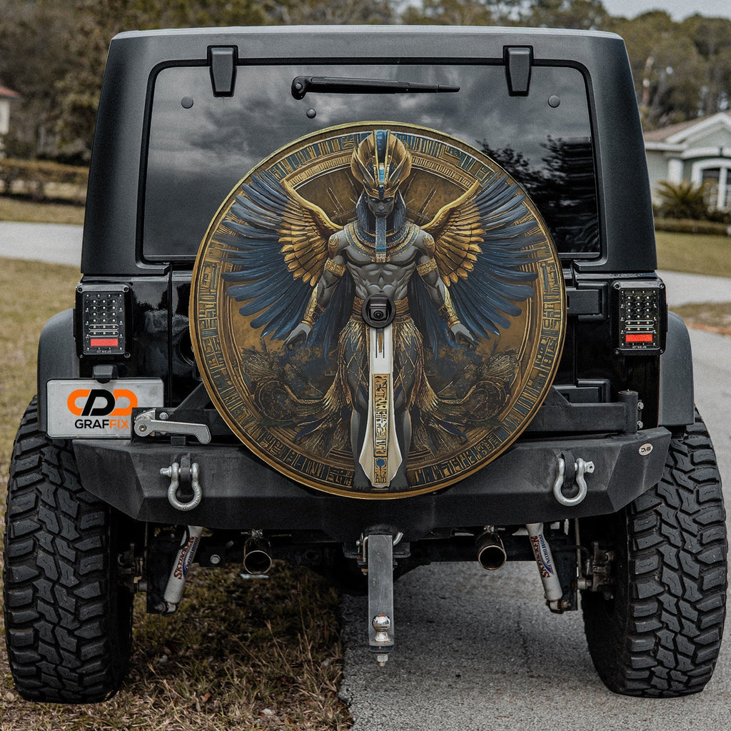 Close-up Egyptian pharaoh winged deity spare tire cover disc showing detailed hieroglyph art and camera hole
