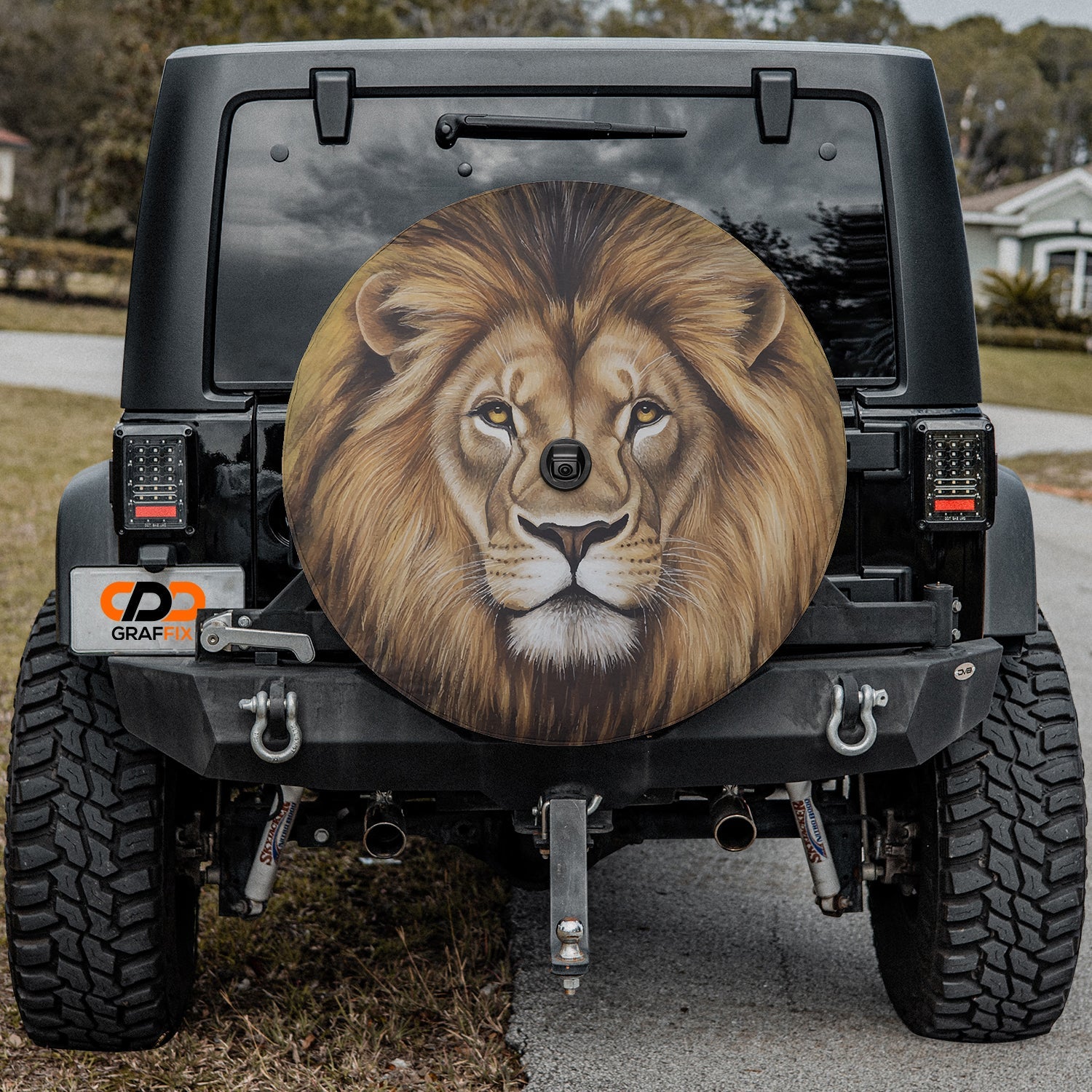Lion of Judah spare tire cover mounted on black Jeep Wrangler rear gate with painted lion portrait art