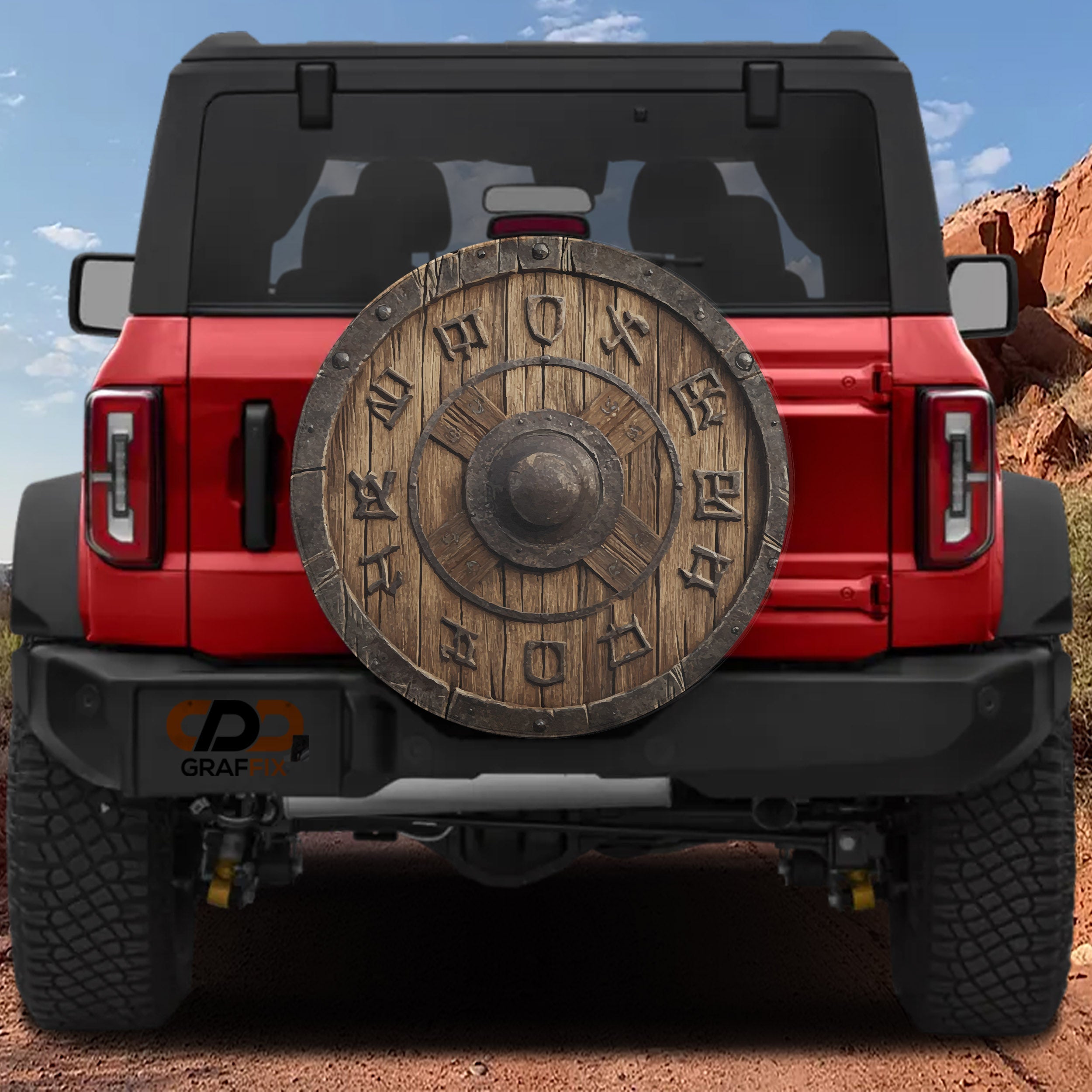 Viking Warrior's Shield spare tire cover on a red Jeep Wrangler with rune carved wooden round shield