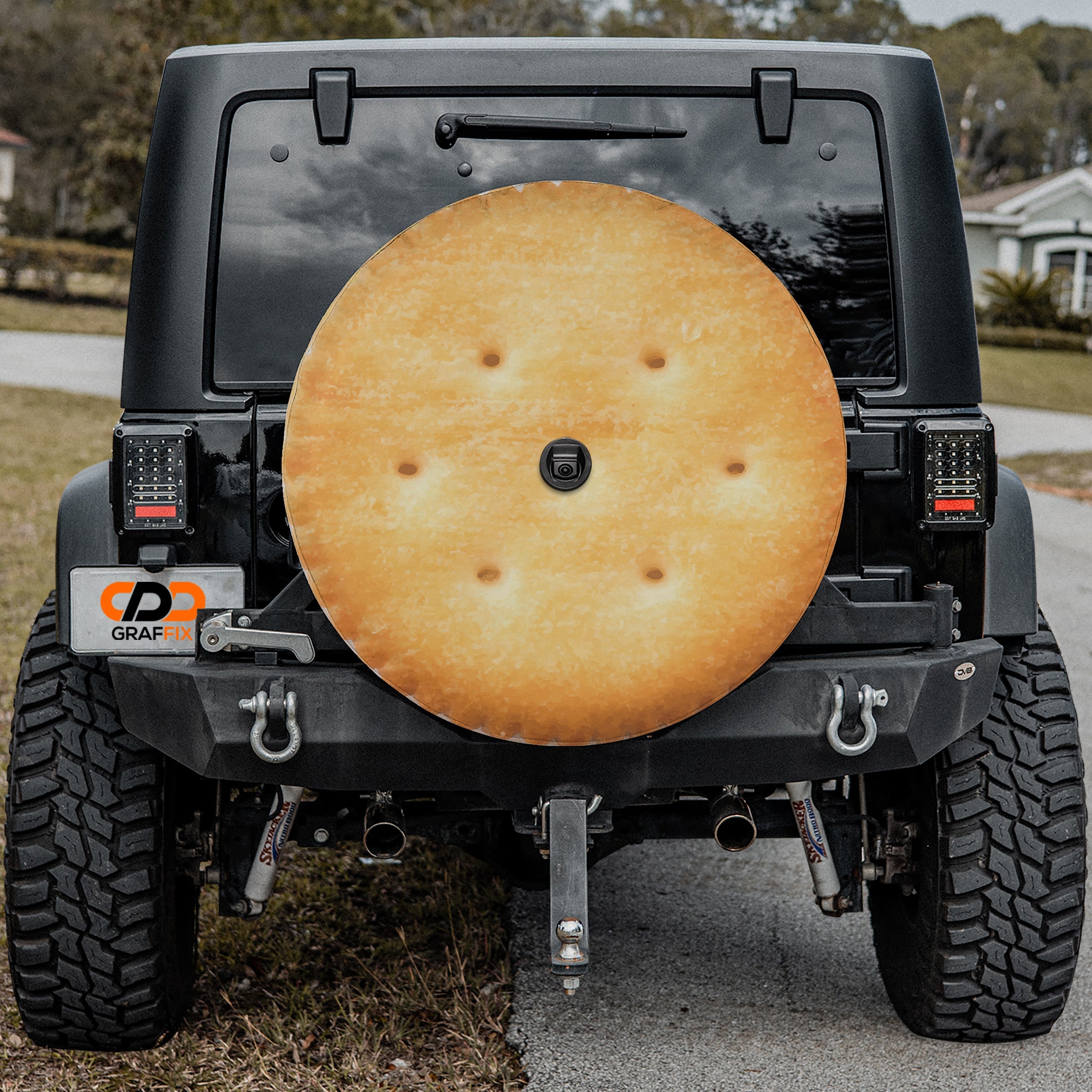 Buttery round cracker stack spare tire cover shown installed on rear of vehicle
