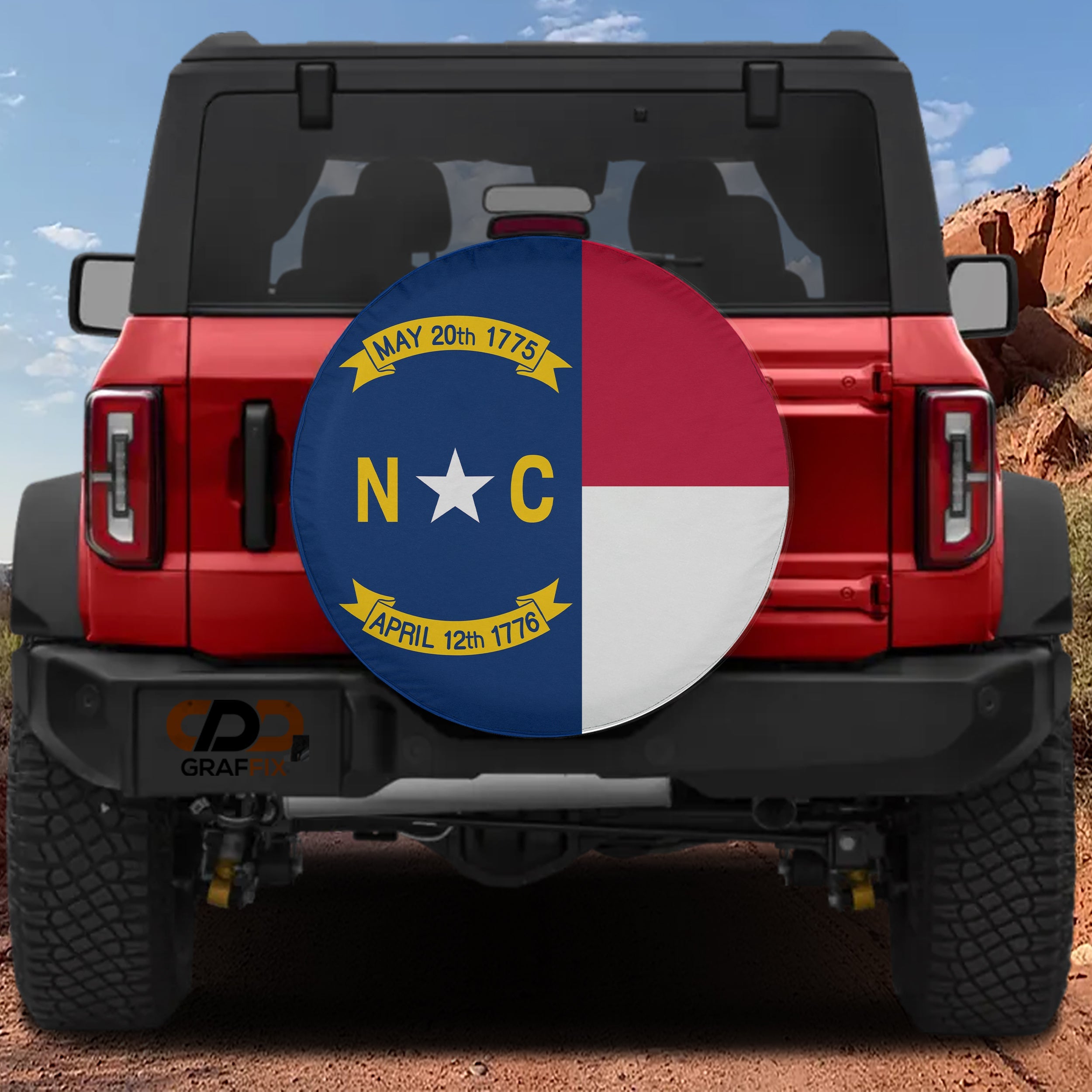 North Carolina state flag spare tire cover on red Ford Bronco with blue red white NC banner