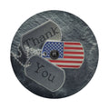 Close-up veterans tribute spare tire cover disc with USA flag dog tags, Thank You text and backup camera hole