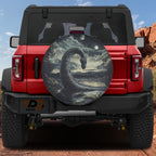 Loch Ness by Moonlight spare tire cover on red Ford Bronco rear with Nessie serpent rising from lake