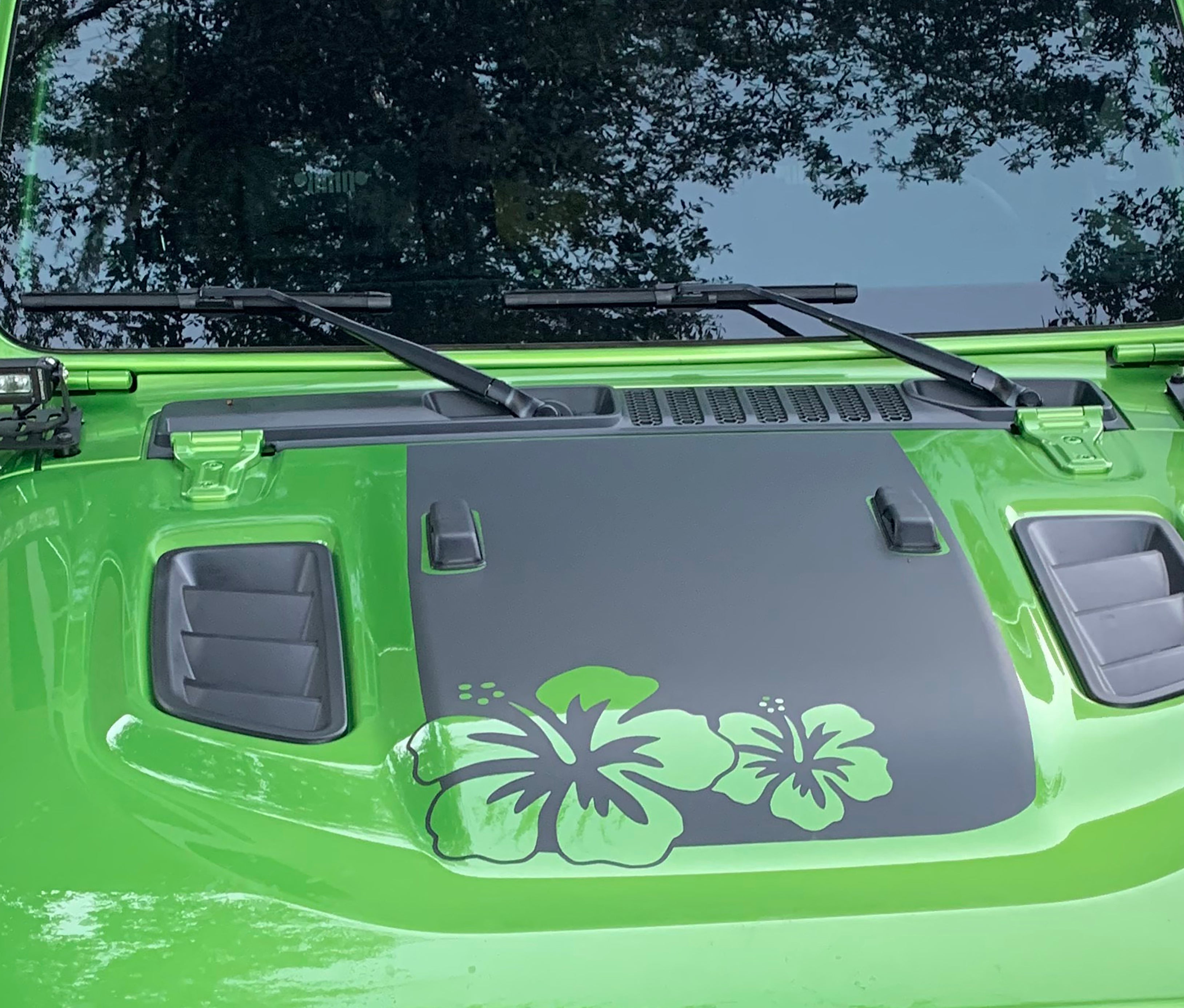 Green hibiscus flowers on power-dome blackout hood decal shown on lime green Jeep Wrangler JL