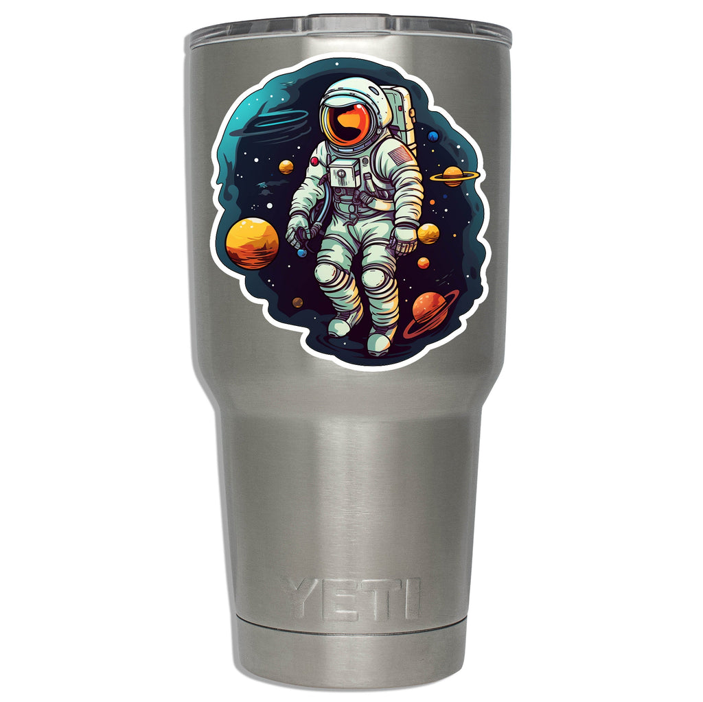 Floating astronaut sticker mounted on a stainless YETI tumbler showing decal size on insulated drinkware