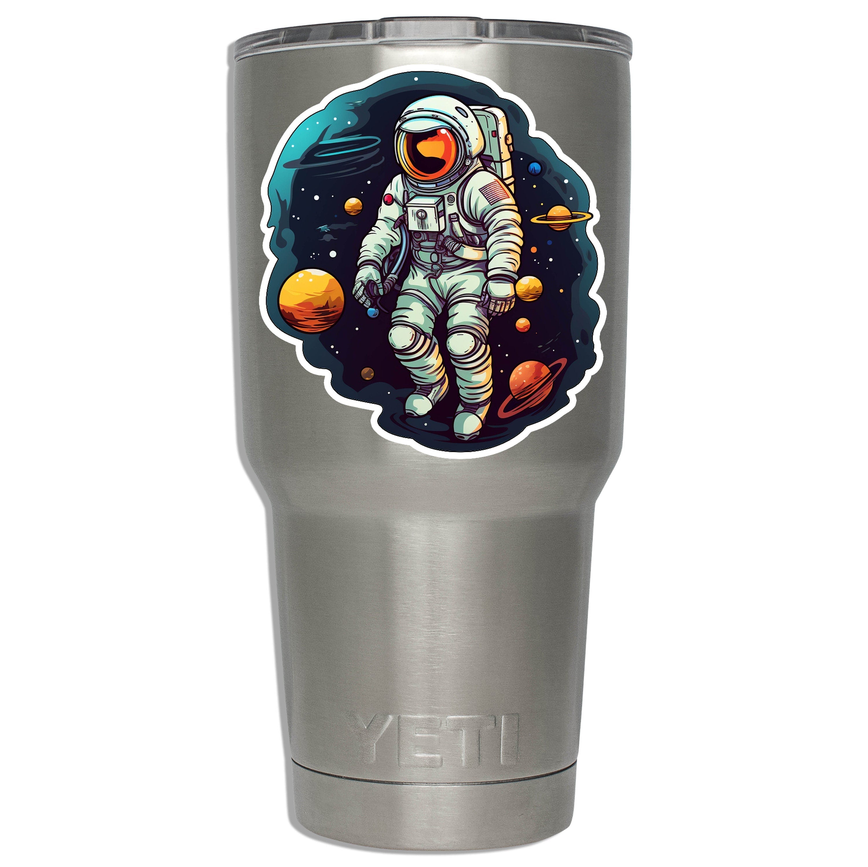 Floating astronaut sticker mounted on a stainless YETI tumbler showing decal size on insulated drinkware