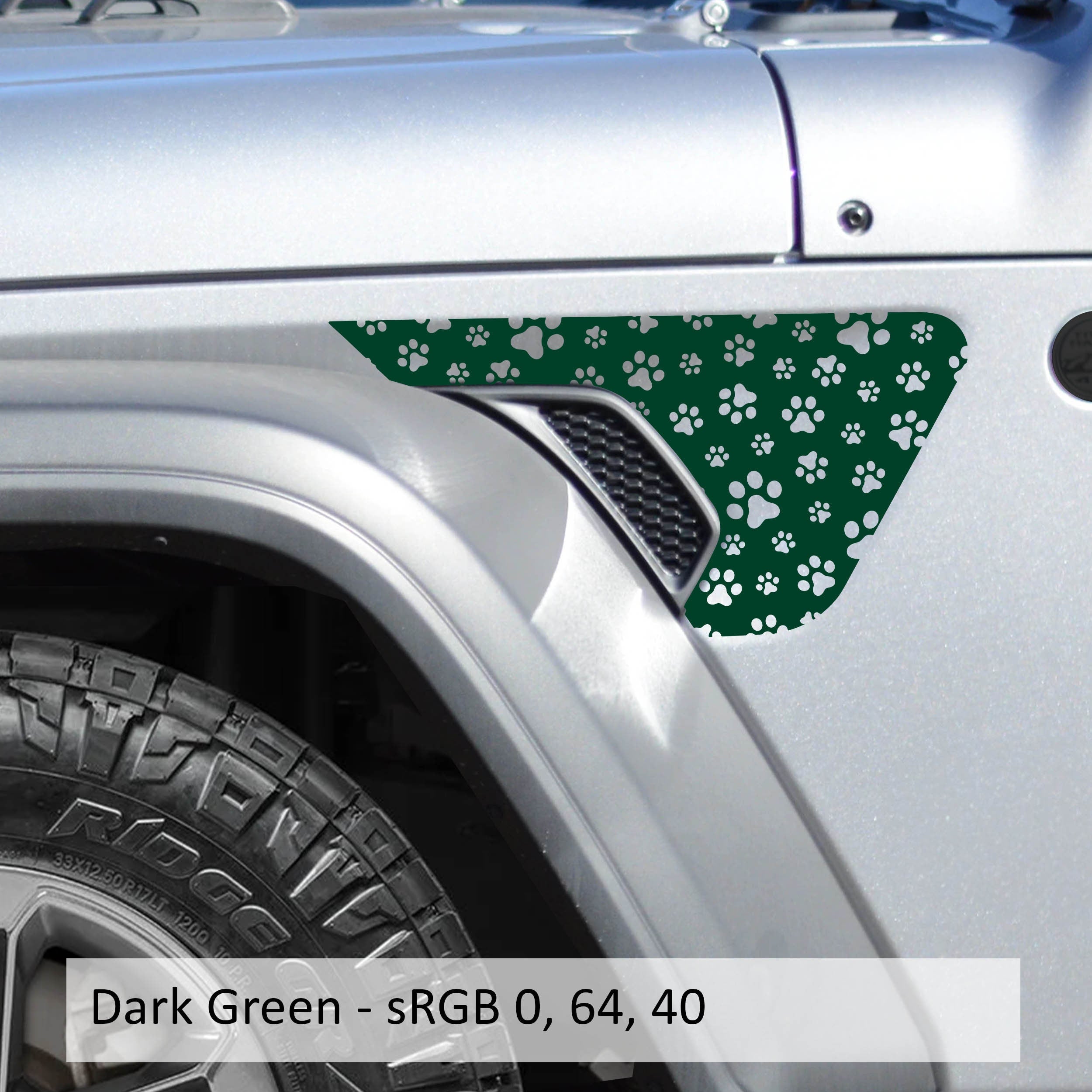 Dark green dog paw print fender vent decal shown installed on silver Jeep Wrangler JL body panel