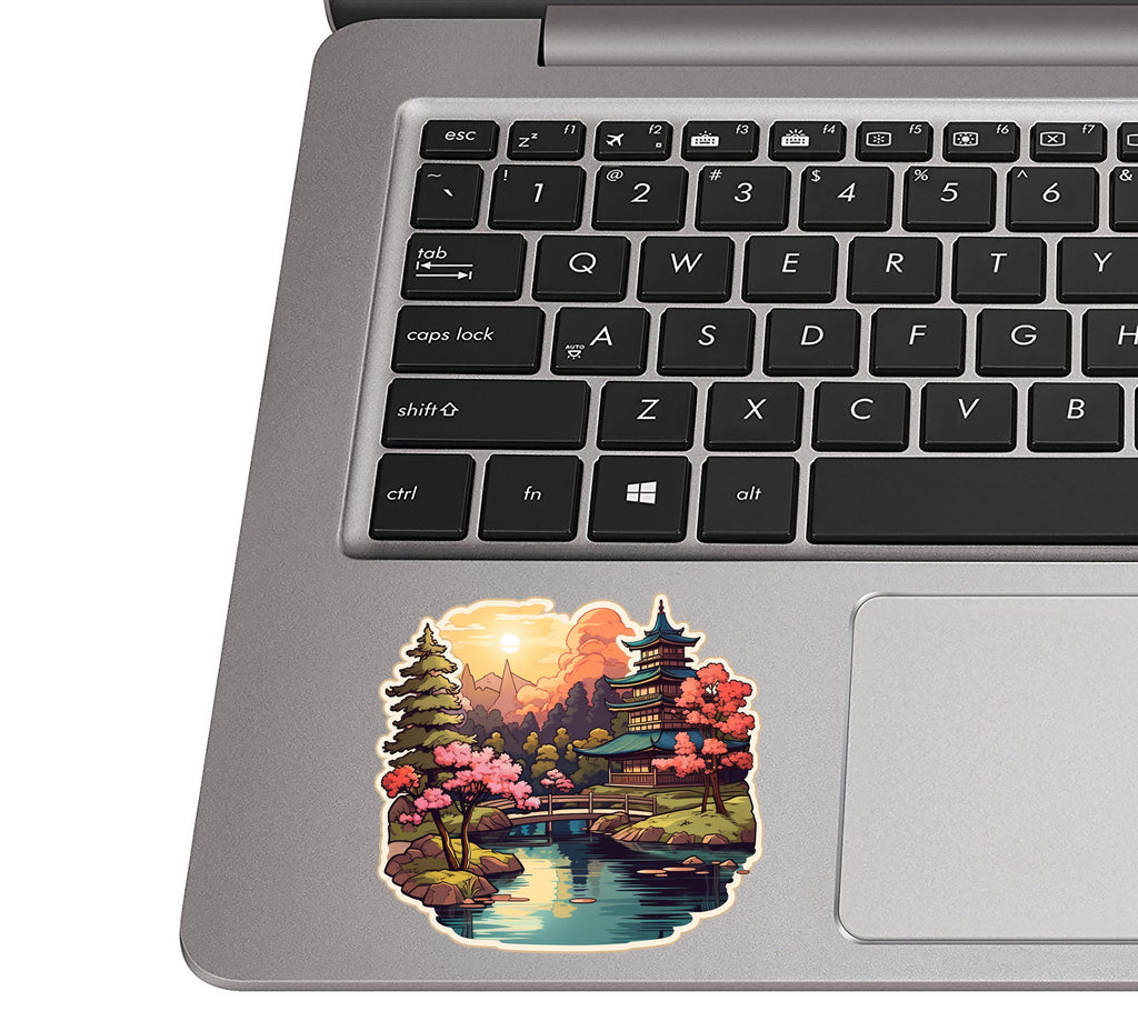 Pagoda garden sticker stuck to a silver laptop palm rest beside the keyboard showing the decal dimensions