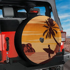 Sunset surfer spare tire cover on red Ford Bronco with palm tree silhouette and surfer holding board at dusk
