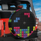 Pixel block puzzle tire cover flat round front view with magenta, blue, green, and yellow falling Tetris bricks