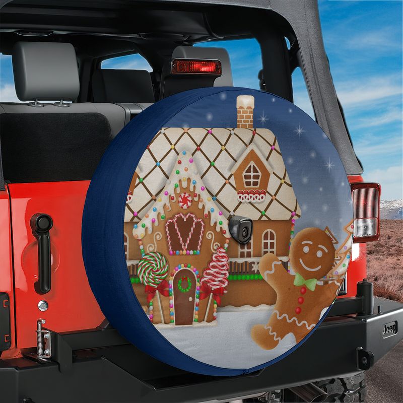 Navy blue Jeep Wrangler spare tire cover with gingerbread house scene and rear camera hole opening