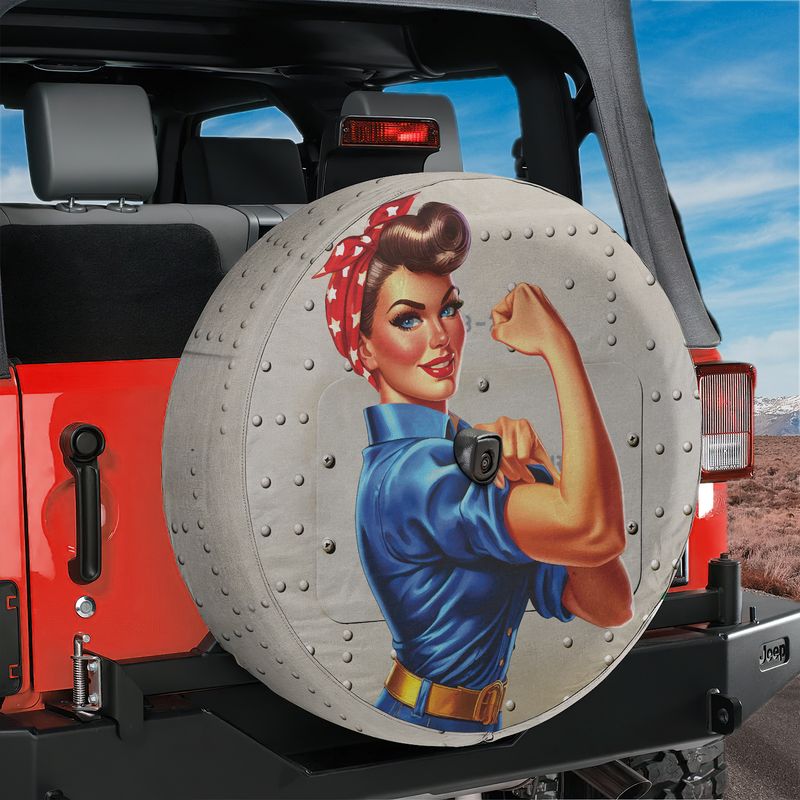 Rosie the Riveter inspired flexing woman spare tire cover mounted on a black Jeep Wrangler tail