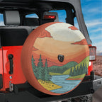 Minimalistic sunset landscape spare tire cover on a red Jeep Wrangler tailgate in a desert mountain view