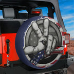 Two Finger Wave American Flag spare tire cover with a backup camera hole on a red Jeep Wrangler