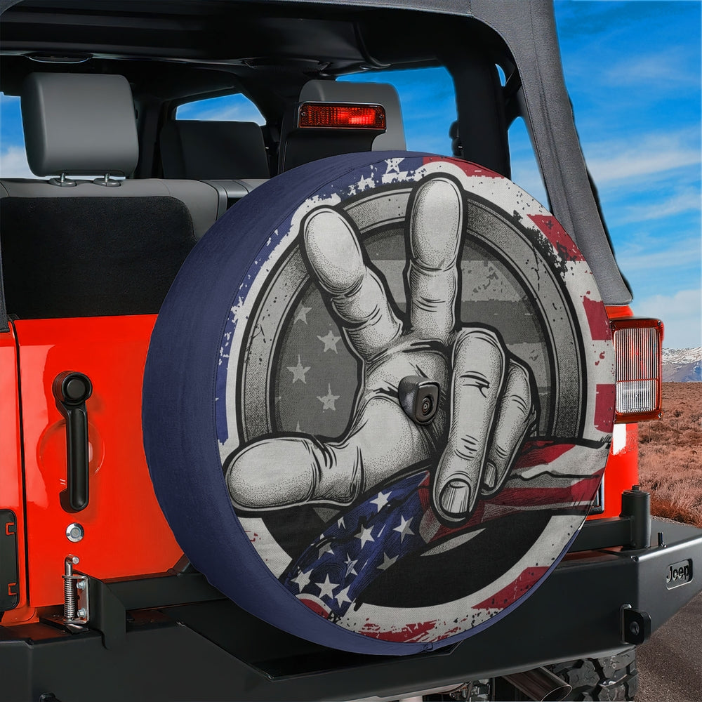 Two Finger Wave American Flag spare tire cover with a backup camera hole on a red Jeep Wrangler