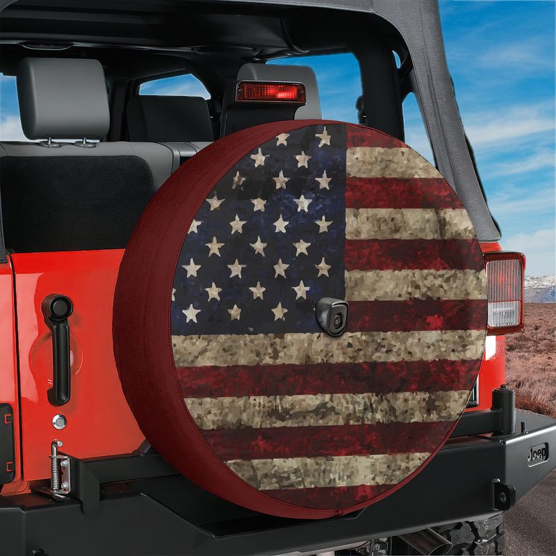 Rustic American flag spare tire cover studio shot showing distressed stars and stripes with backup camera cutout