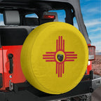 New Mexico State Flag spare tire cover on red Ford Bronco rear with yellow field and red Zia sun