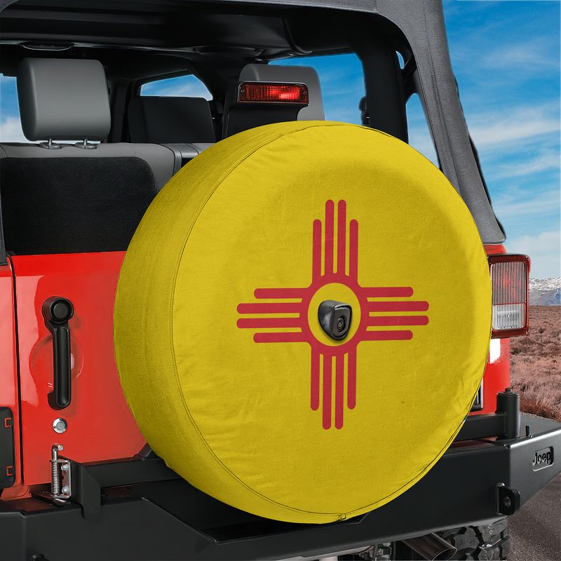 New Mexico State Flag spare tire cover on red Ford Bronco rear with yellow field and red Zia sun