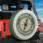 Travel compass spare tire cover on red Jeep Wrangler with green badge and brown compass rose design