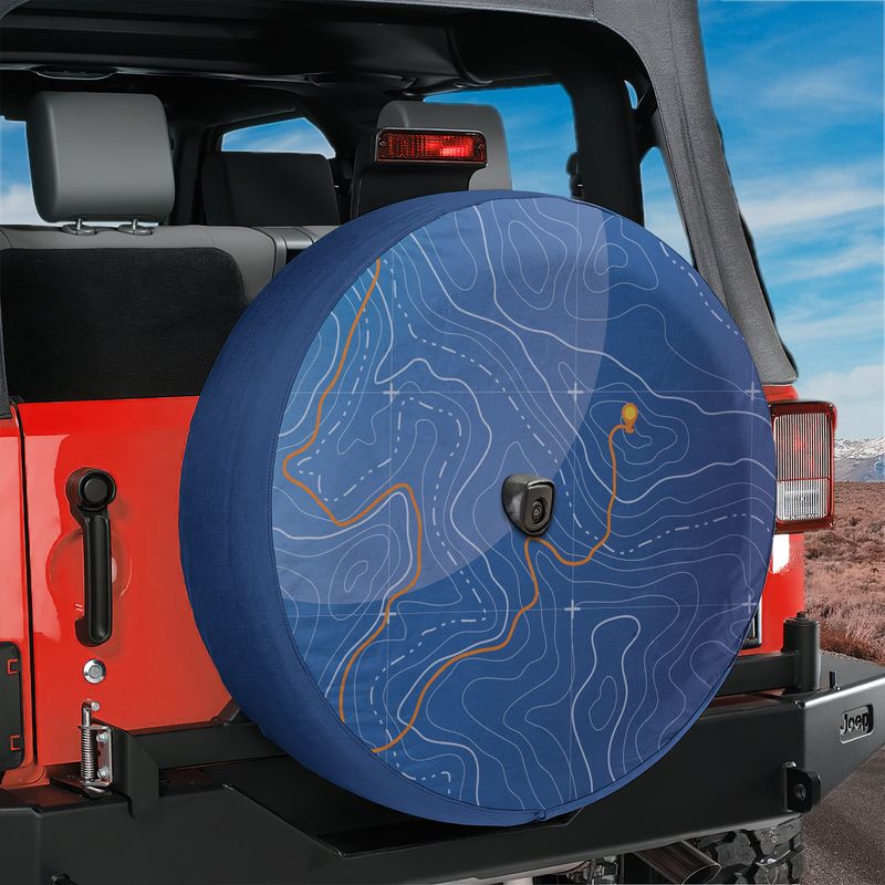 Topographic trails spare tire cover on a red Jeep Wrangler tailgate with blue contour line map graphic