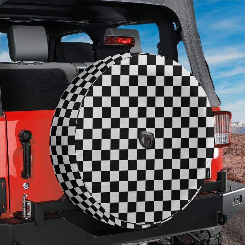 Black and white checkered board spare tire cover shown mounted on red Jeep Wrangler back